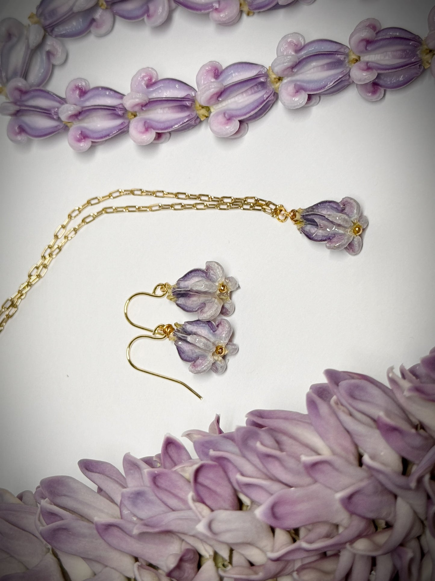 Pua Kalaunu purple dangle necklace on gold chain and earring set