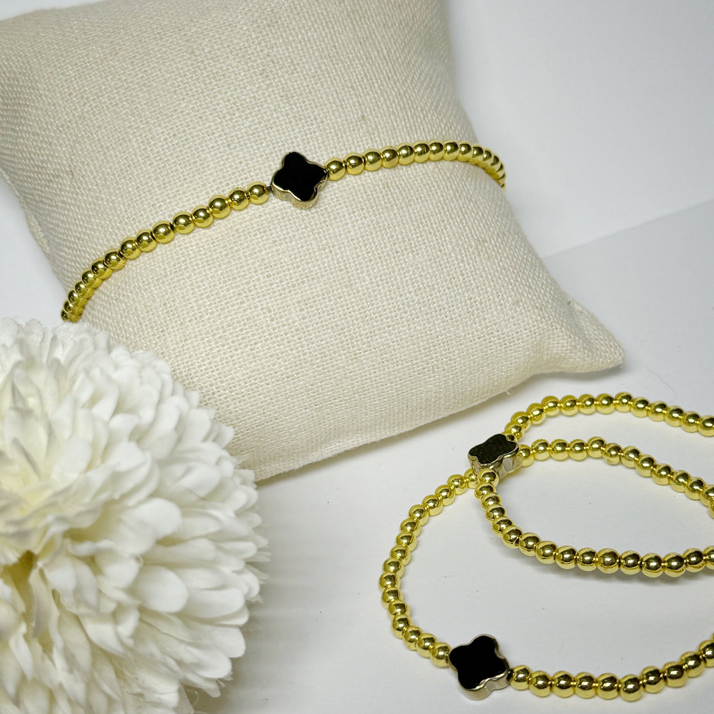 Fancy pua clover pendant on gold stretch bracelet size medium